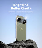 Pixel 11 Pro Case | Fusion - A clear smartphone case shown on a phone, standing on dark rocks against a light blue gradient background. White text at the top reads 'Brighter & Better Clarity' with smaller supporting text below, and small disclaimer text appears near the bottom.