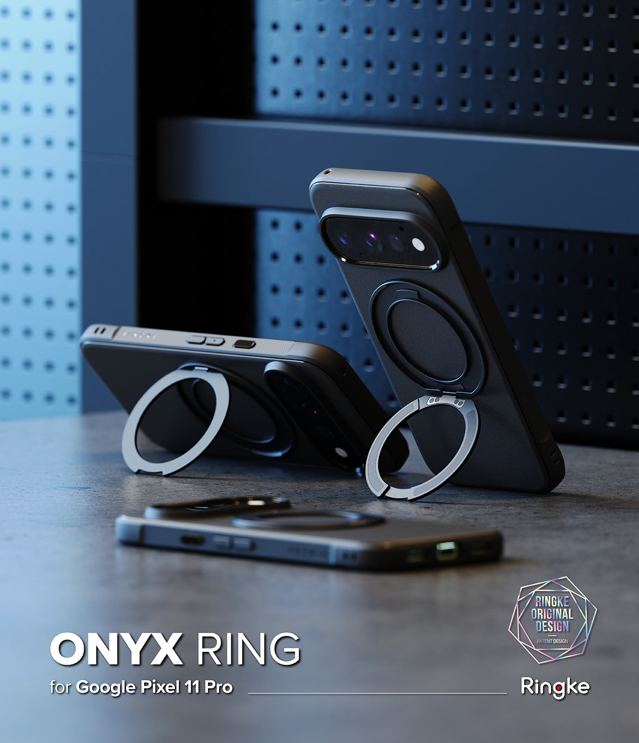 Google Pixel 11 Pro Case | Onyx Ring - Three black magnetic phone cases with circular ring stands are displayed on a dark tabletop against a blue perforated panel background. One case stands upright on a ring stand, one lies horizontal, and one is shown from the back.