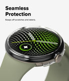 Pixel Watch 5 / 4 41mm | Case + Screen (2P) - A smartwatch with a round silver-toned case and a light olive green strap, shown on a clean white background with promotional text reading 'Seamless Protection' and 'Keeps off scratches and debris.' The watch face displays a green and black patterned screen design.