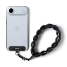 Holder Link Puffer | Hand - Clear phone case with black strap on a white background