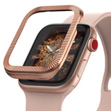 Apple Watch Series 3 / 2 / 1 (38mm) | Premium Bezel Styling O - Rose gold ridged bezel cover hovering over a watch.