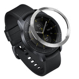 Galaxy Watch (42mm) | Bezel Styling - A silver, fluted metal bezel ring hovering above a black Galaxy Watch with a silicone strap.