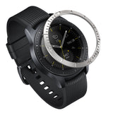 Galaxy Watch (42mm) | Bezel Styling - Stainless steel bezel ring hovering above a black smartwatch with a ribbed strap.