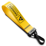 Key Ring Strap | Danger - Yellow strap with black Danger text and warning icon attached to a clear AirPods case.