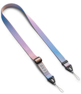 Design Shoulder Strap - Person wearing a colorful, adjustable crossbody strap attached to a smartphone case.
