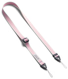 Design Shoulder Strap - A smartphone in a clear case attached to a grey adjustable shoulder strap resting on an open book.