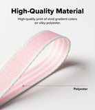 Design Shoulder Strap - Hands adjusting a pink and white fabric strap with black plastic buckles over a notebook.