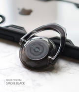 Prism Ring - A translucent smoke black Ringke phone ring holder with a faceted, gem-like design on a marble surface.