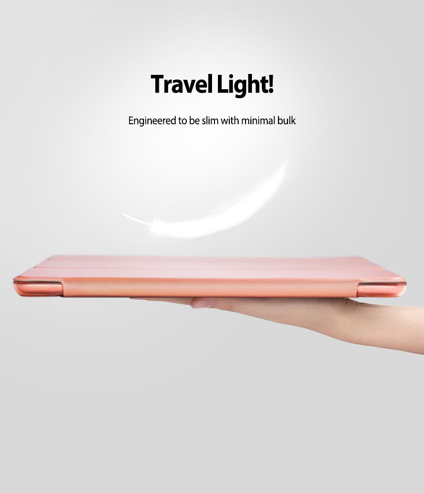 Smart Cover Apple Pencil Stand | iPad - A slim rose gold tablet case held horizontally by a hand against a light gray background, with text above reading 'Travel Light! Engineered to be slim with minimal bulk' and a white feather graphic.