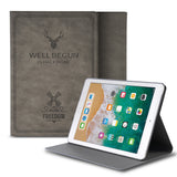 Smart Cover Design Leather Stand | iPad - Gray leather case with deer and windmill design behind an iPad in a stand.
