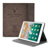 Smart Cover Design Leather Stand | iPad - Brown leather case with deer and windmill graphics standing behind an iPad.