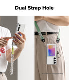 Phone case with dual strap hole feature, held by a person and worn on a lanyard strap.