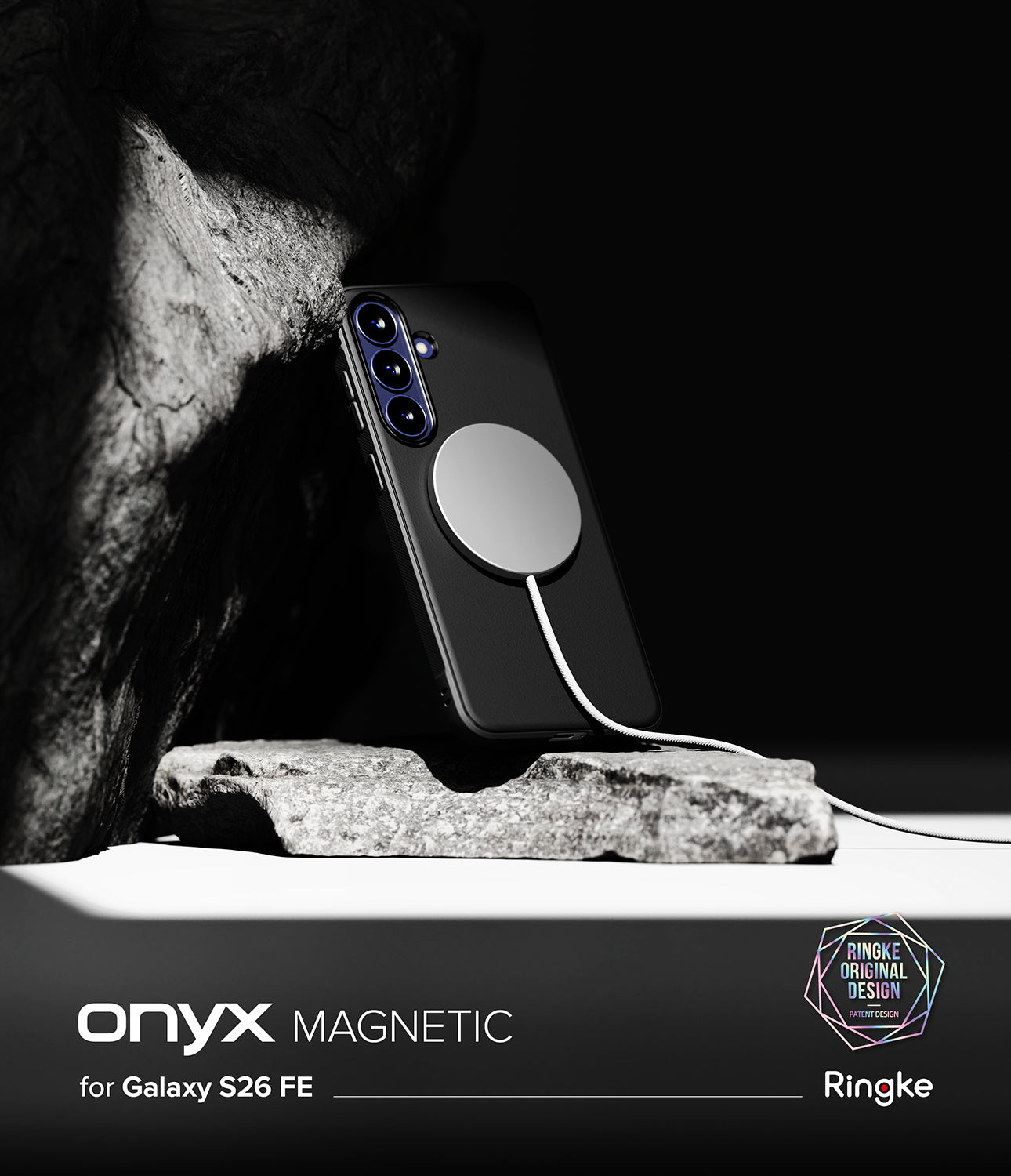 Galaxy S26 FE Case | Onyx Magnetic - A black phone case with a large circular magnetic ring, shown attached to a smartphone and resting on a rock against a dark background. Text at the bottom reads 'onyx MAGNETIC for Galaxy S26 FE' with Ringke branding.