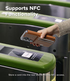 Galaxy S26 Ultra Cover | Folio Stand Wallet Magnetic - Galaxy S26 Ultra Cover - Hand holding a brown leather wallet phone case over a subway turnstile for NFC payment.