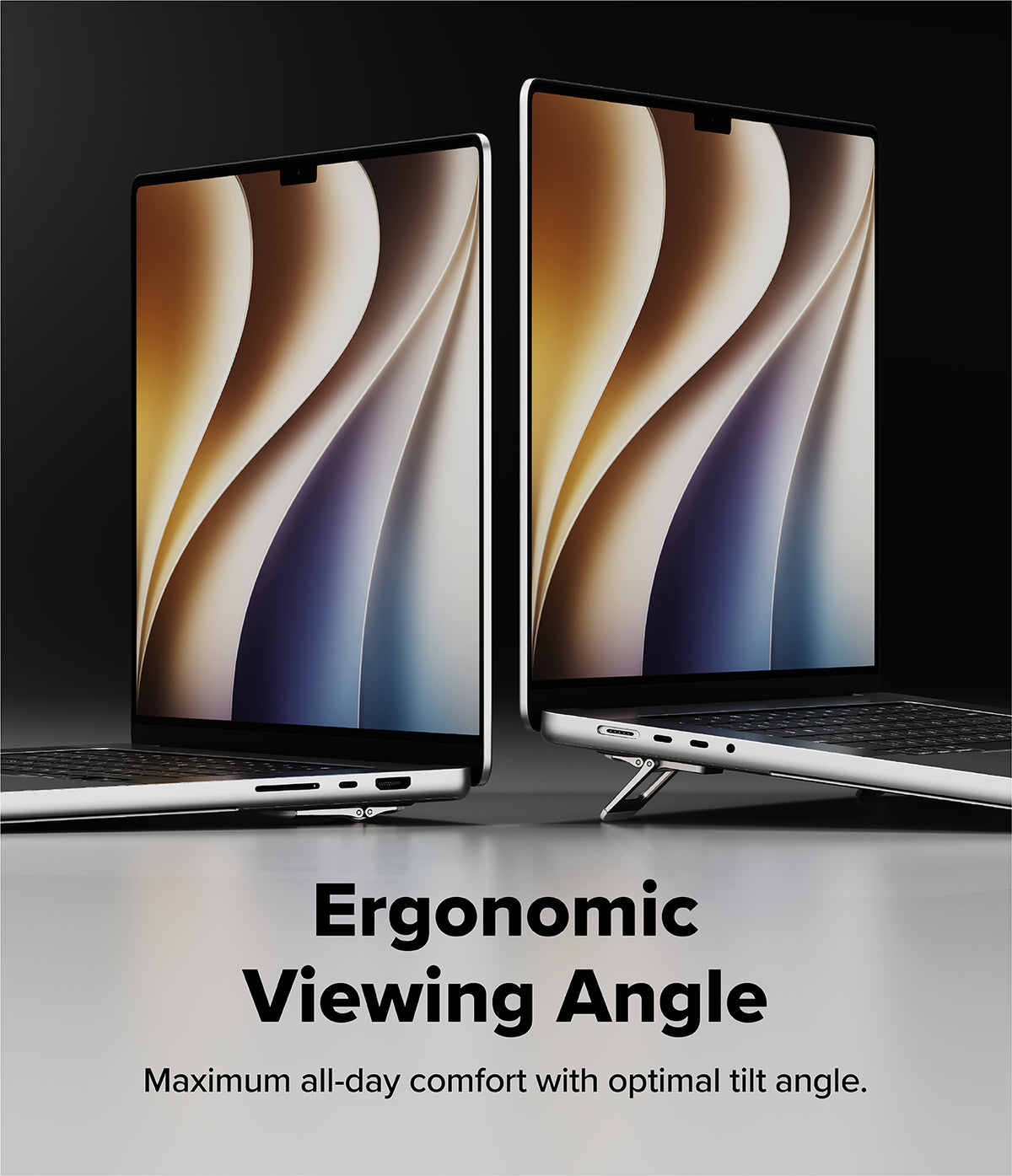 Step-Fit Mini Stand - Two silver laptops shown at an ergonomic viewing angle on a dark studio background, with text below reading 'Ergonomic Viewing Angle' and 'Maximum all-day comfort with optimal tilt angle.'.