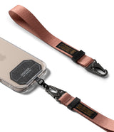 Holder Link Tactical Webbing Hand Strap - Rose gold nylon wrist strap with black metal carabiner attached to a phone.