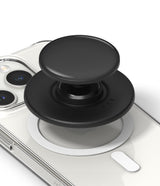 Ringke Glossy Tok Magnetic - A black circular magnetic phone grip attached to the back of a clear smartphone case.
