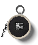 Mini Pouch | Tambourine Bag - Round black pouch with beige trim, carabiner, and branded patch on a white background.