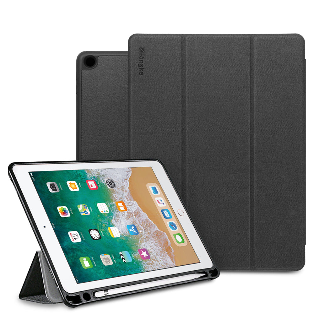 Smart Cover Apple Pencil Stand | iPad - A dark gray tri-fold tablet case shown with a tablet in front, standing in landscape orientation on its kickstand. The back cover of the case is shown upright behind it.