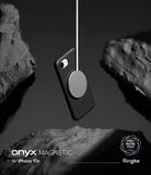 iPhone 17e Case | Onyx Magnetic - Black phone case suspended by a magnetic charger between dark, jagged rocks.