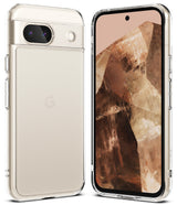 Google Pixel 8a Case | Fusion - Clear phone case standing next to a light-colored smartphone surrounded by floating glass orbs.